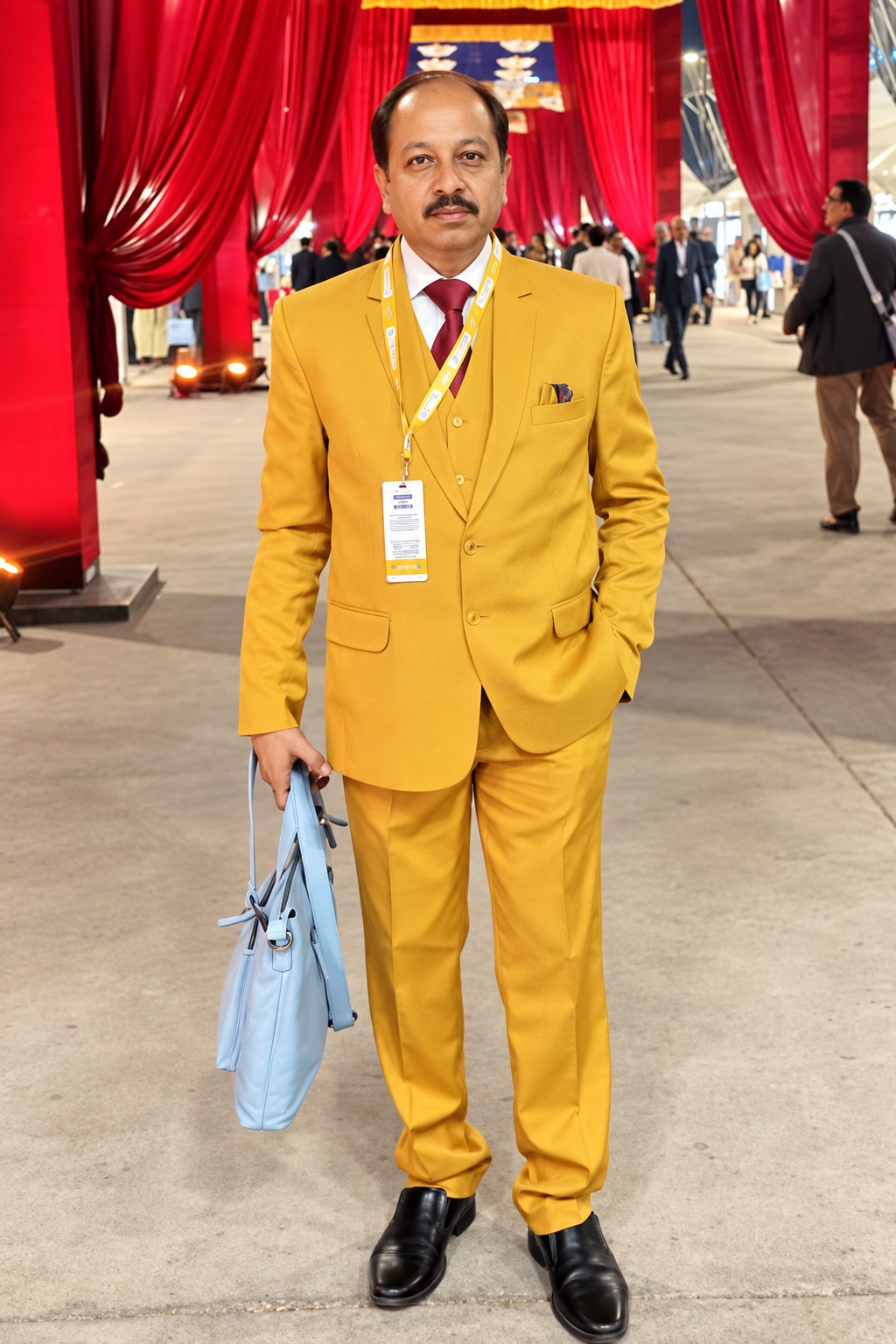 Chiranjib Ghosh in a formal yellow suit