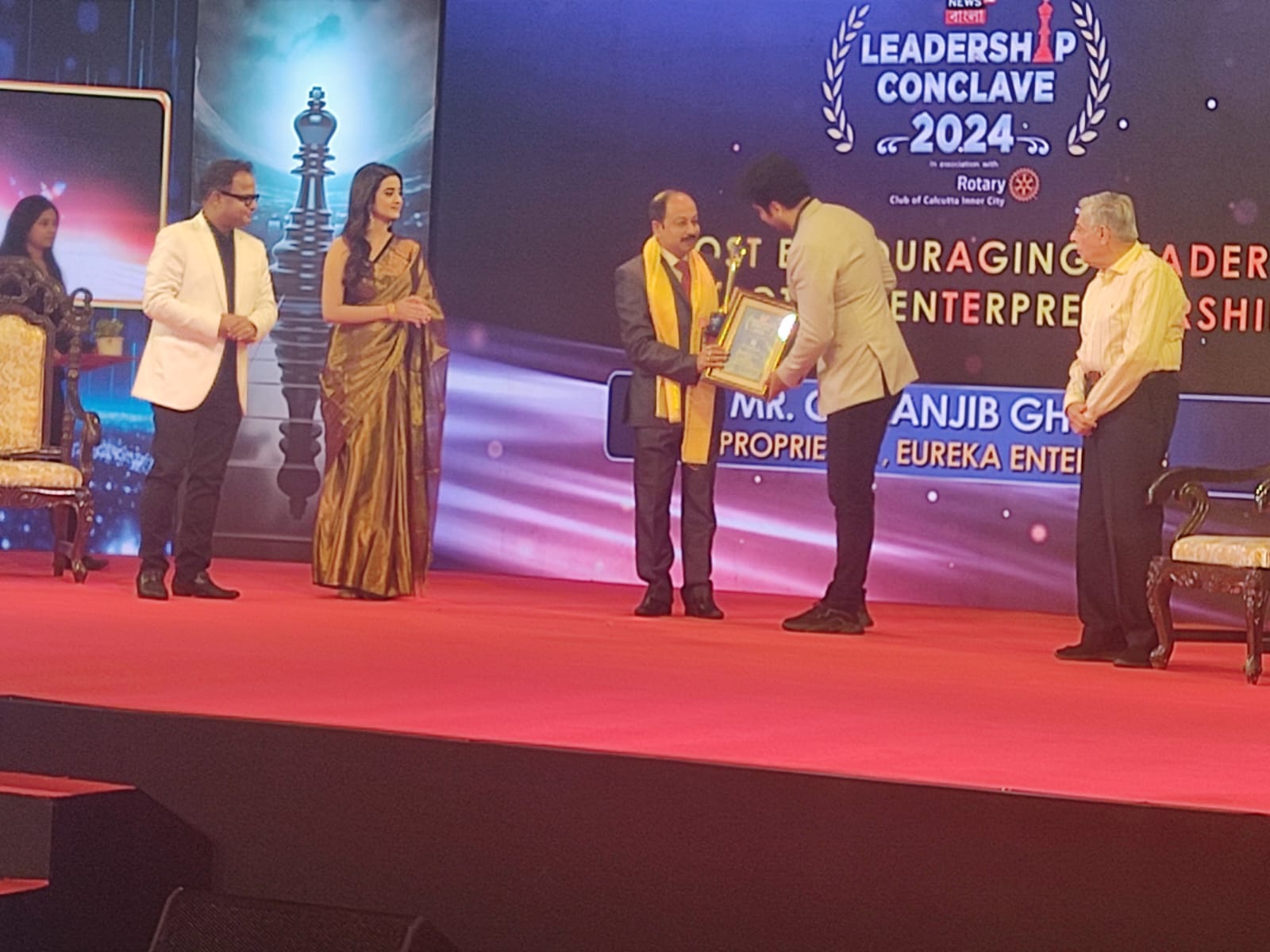 Chiranjib Ghosh receiving recognition on an award stage